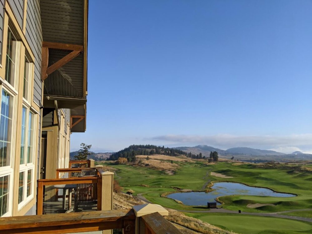 Looking out from Predator Ridge Resort lodge balcony towards golf course with large lake in middle