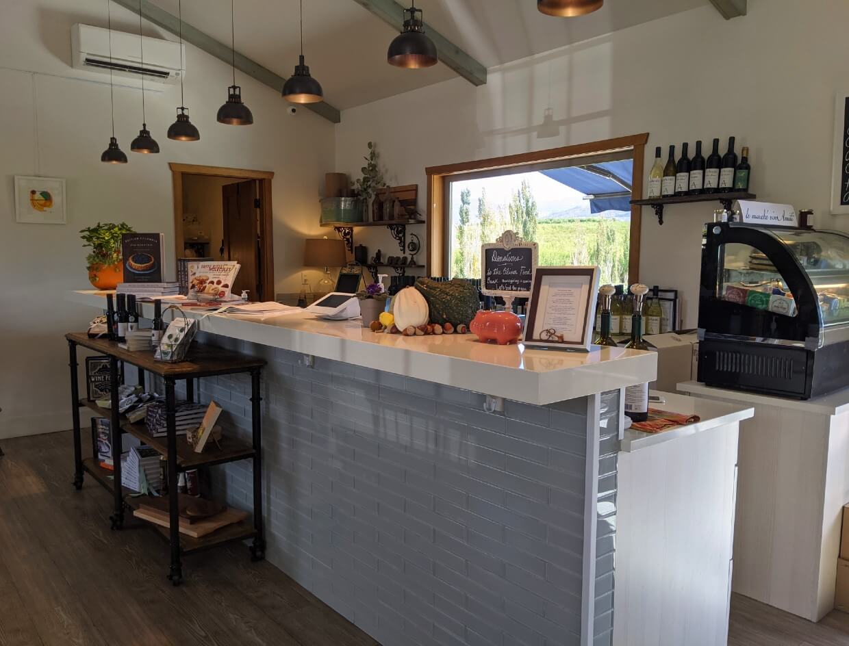Modern tasting bar with cheese deli cabinet, inside VinAmité Wine Lounge