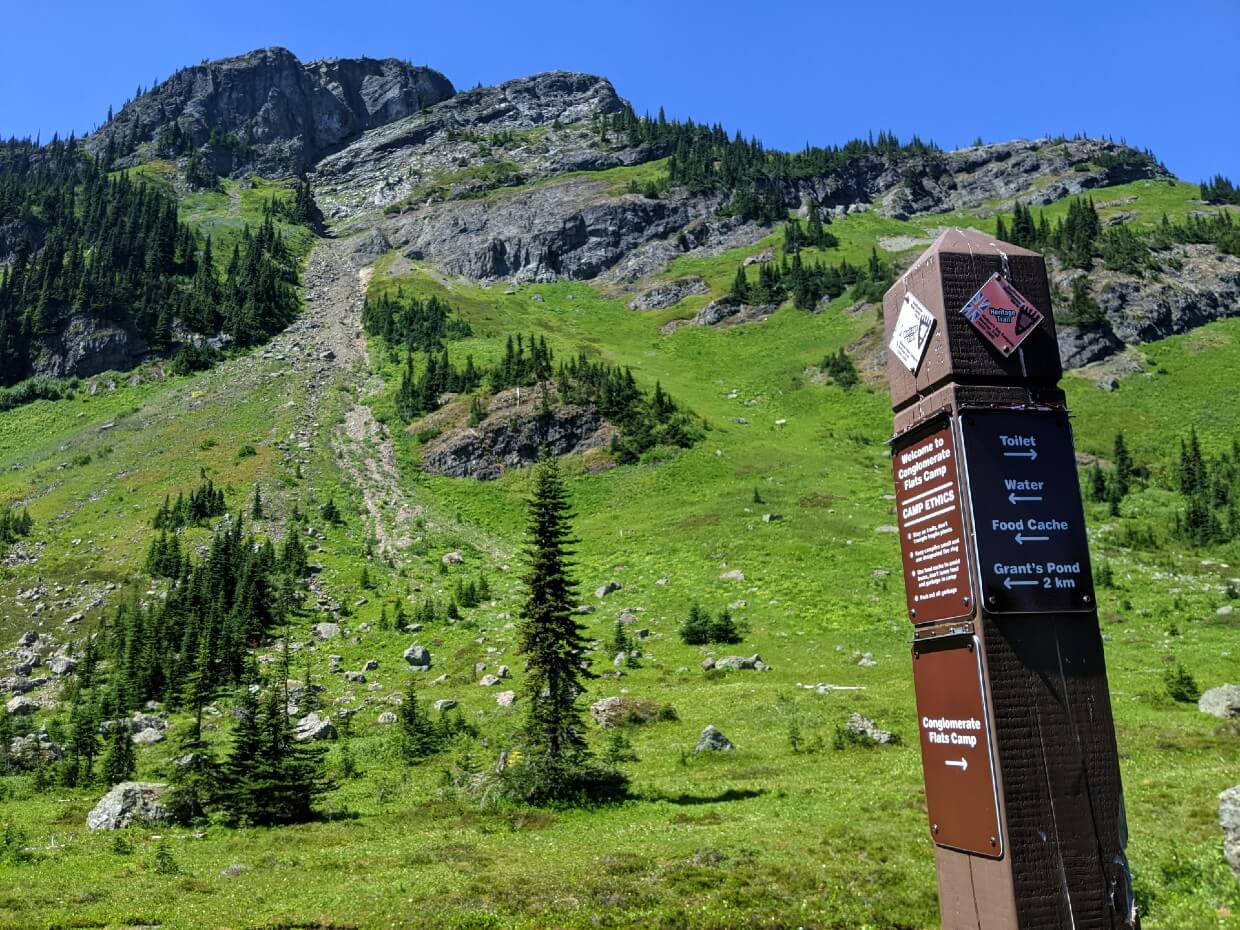 View of rocky Mount Davis with hiking trail sign in foreground at Conglomerate Flats