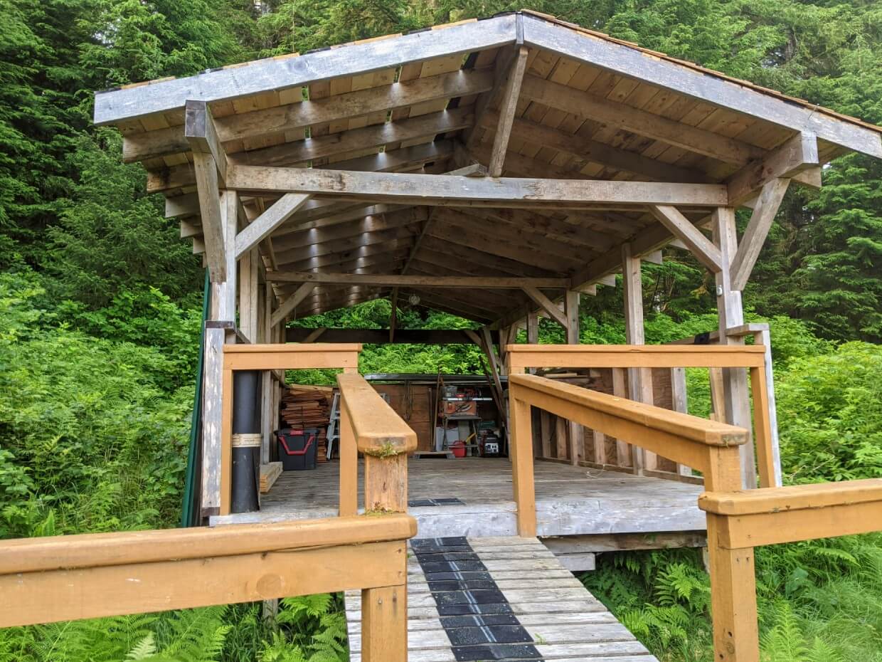 Close up look of covered tent deck, which is a simple rectangle wooden structure with sloped roof