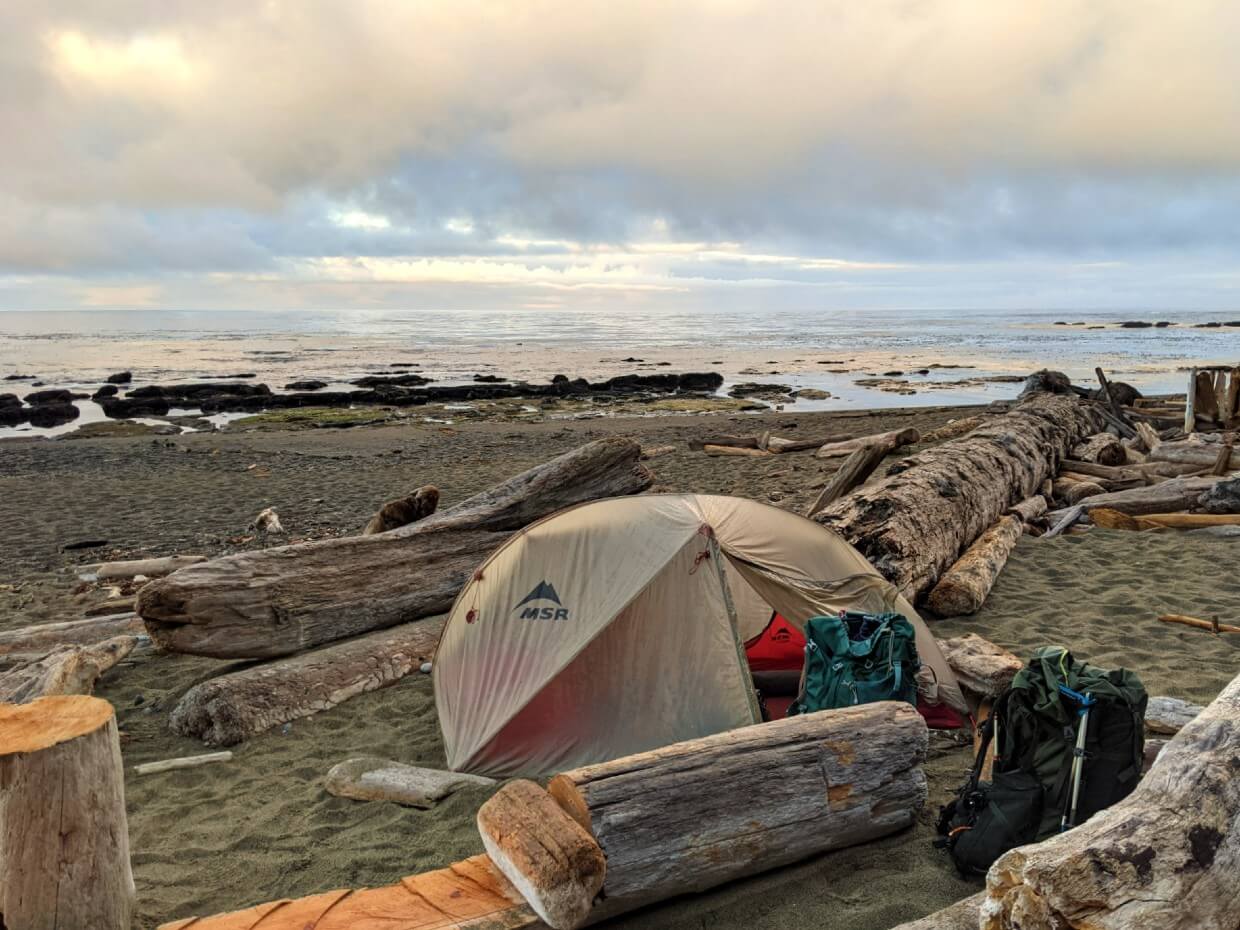 Set up tent on beach in front of ocean - the tent walls are clearly wet with condensation