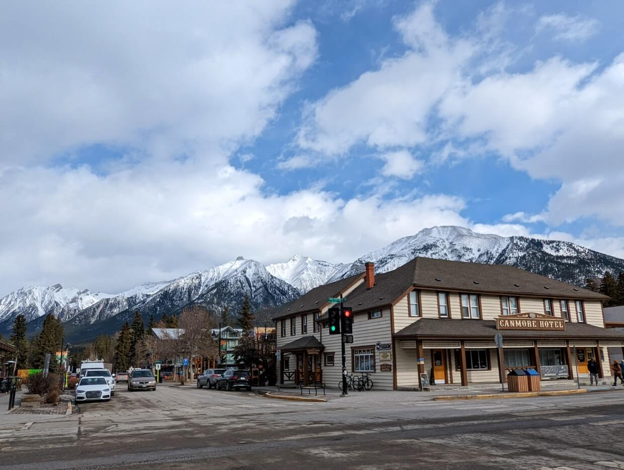The wooden Canmore hotel in downtown area, in front of snowy mountains