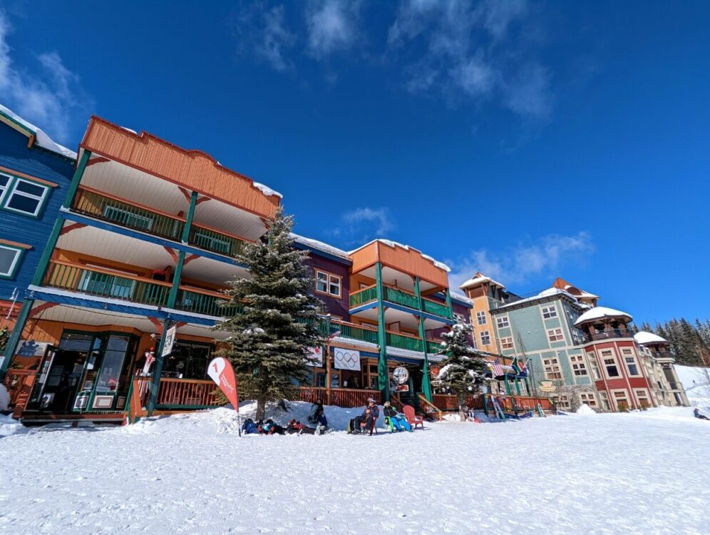 Looking up to colourful buildings on a blue sky day at Silver Star Ski Resort near Vernon