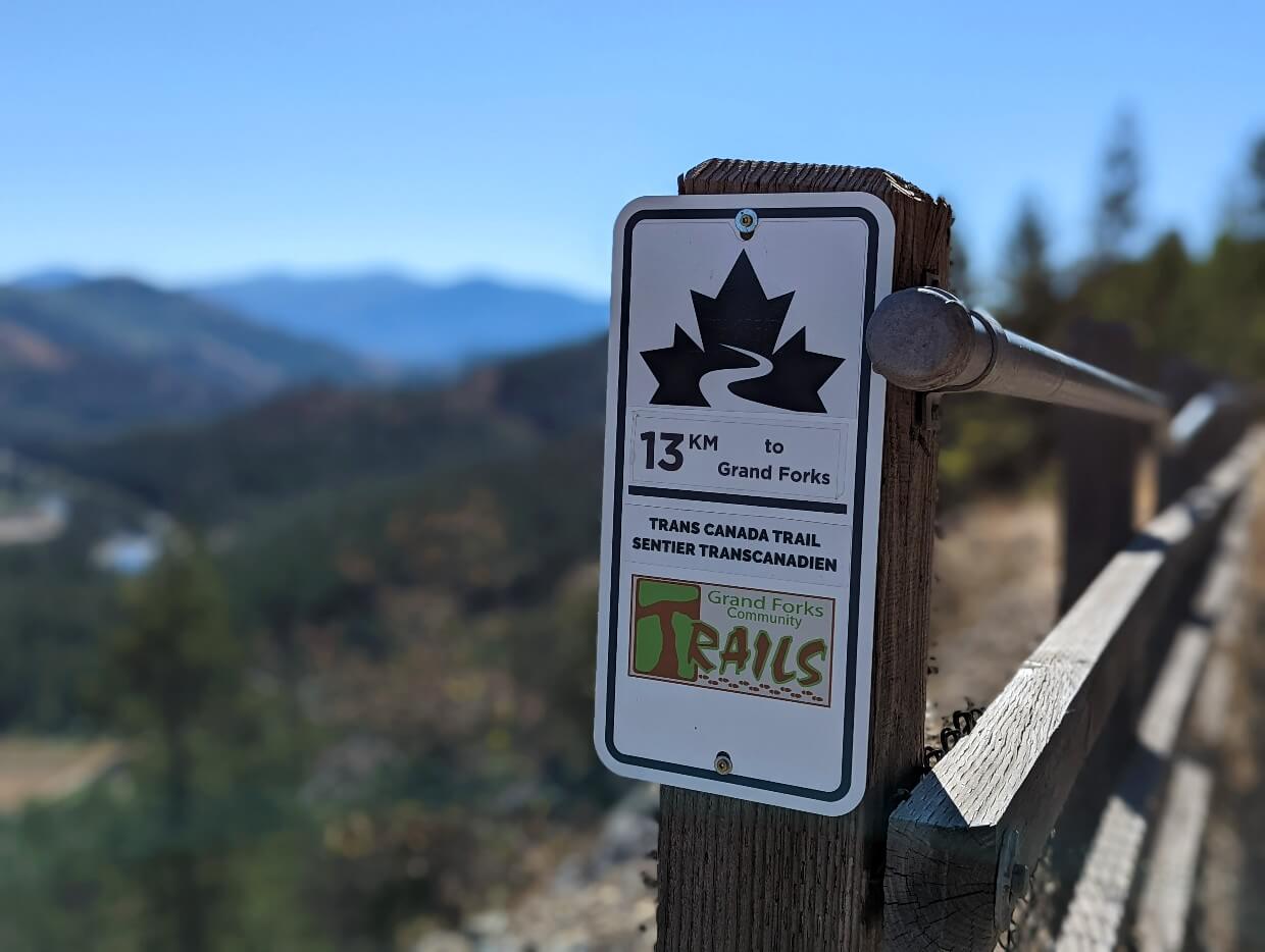 Close up of Trans Canada Trail sign on fence on Columbia and Western Rail Trail near Grand Forks