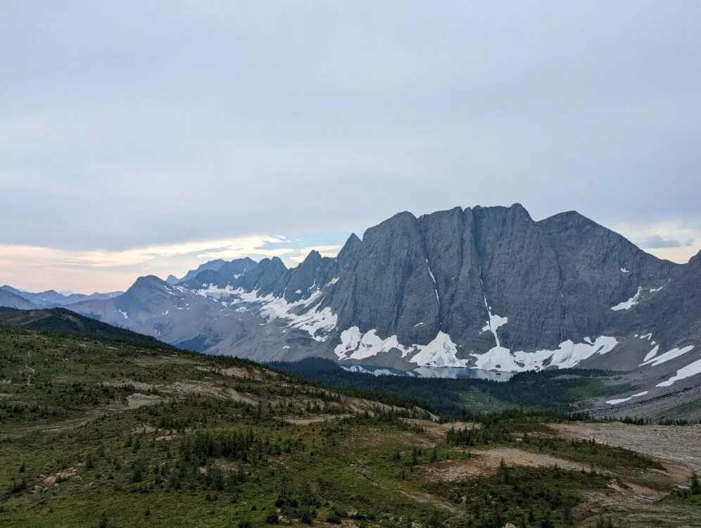 Looking down on Floe Lake from Numa Pass, with turquoise lake visible at the base of a range of huge mountains