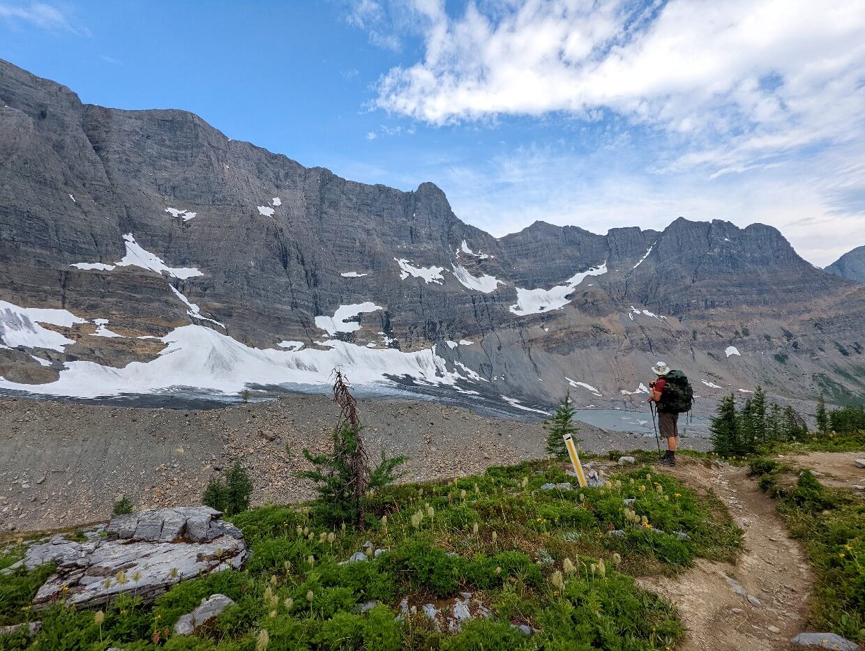 Side view of JR standing and taking in the vistas below Tumbling Glacier
