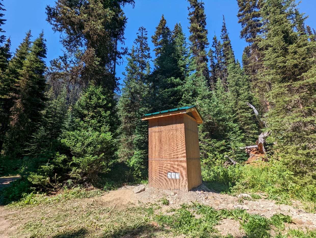 Individual wooden outhouse in forest area in Helmet Ochre Junction campground