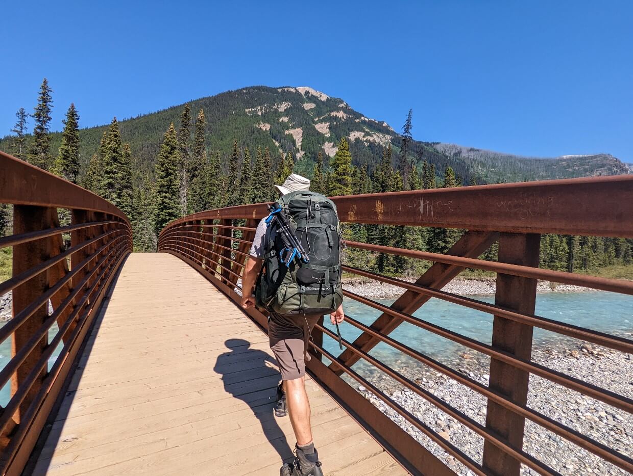 Back view of JR as he crosses the bridge above Kootenay River