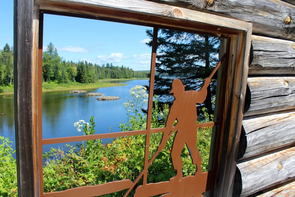 Partial metal and wood structure in front of lake scenery in Parc national du Lac‑Témiscouata