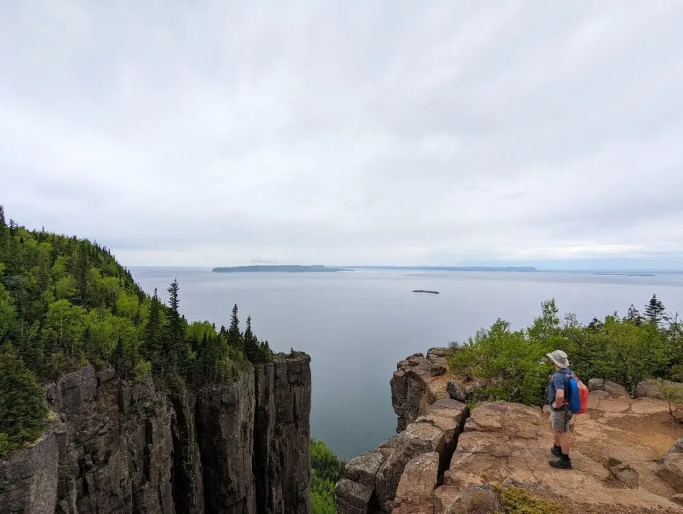 Back view of JR at Gorge Lookout, taking in the views of Lake Superior and the steep drop-off below