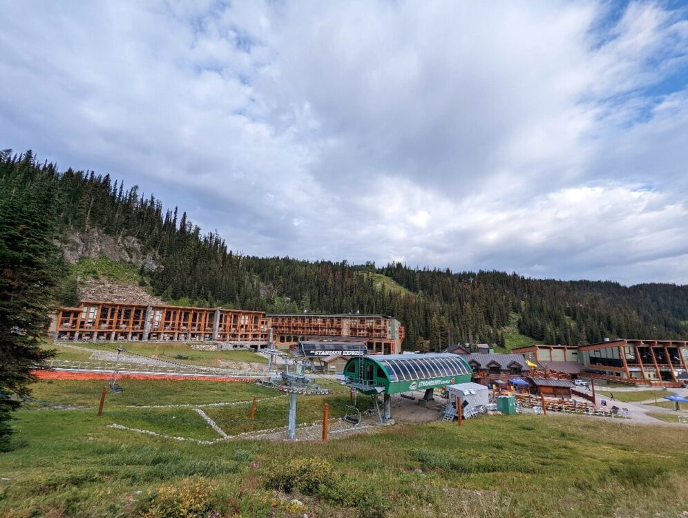 Looking across to Sunshine Village with green ski lift and three story hotel in background (Sunshine Mountain Lodge)