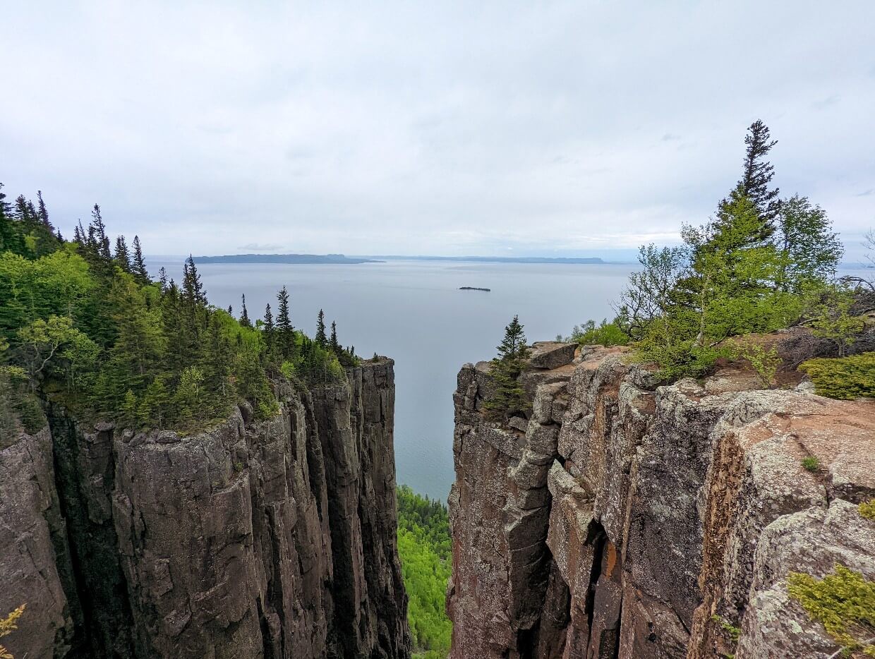 Viewpoint on Top of the Giant Trail looking down deep gorge with Lake Superior in background