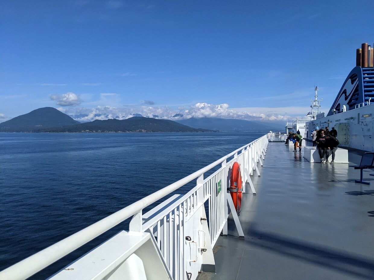 Vancouver Island ferry view from open deck, with white fence and islands visible in background