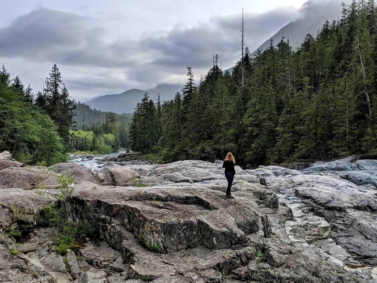 Back view of Gemma standing on rock at Wallys Creek on Highway 4 to Tofino