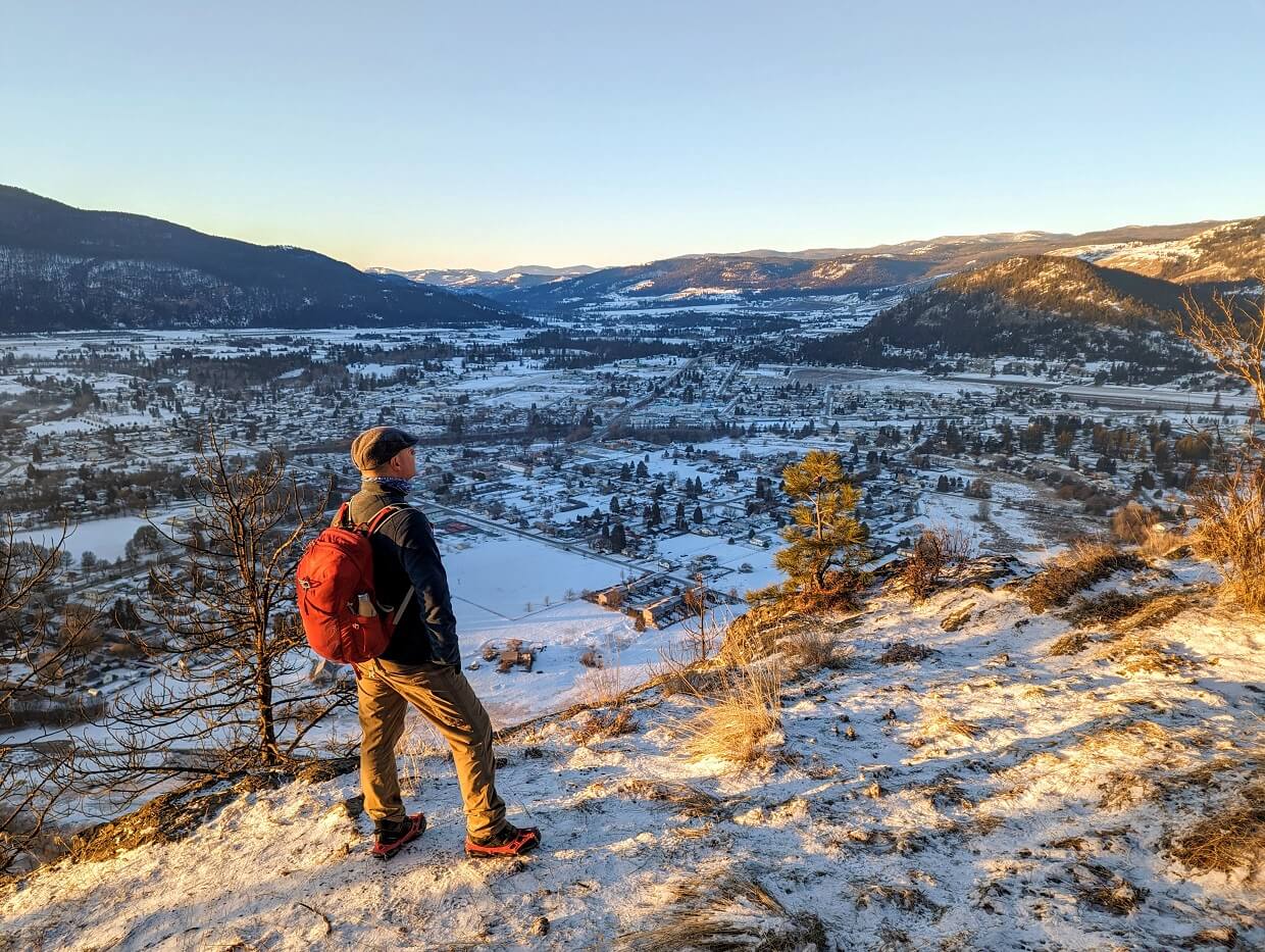Back view of JR standing on Observation Mountain looking right, with snowy town of Grand Forks below