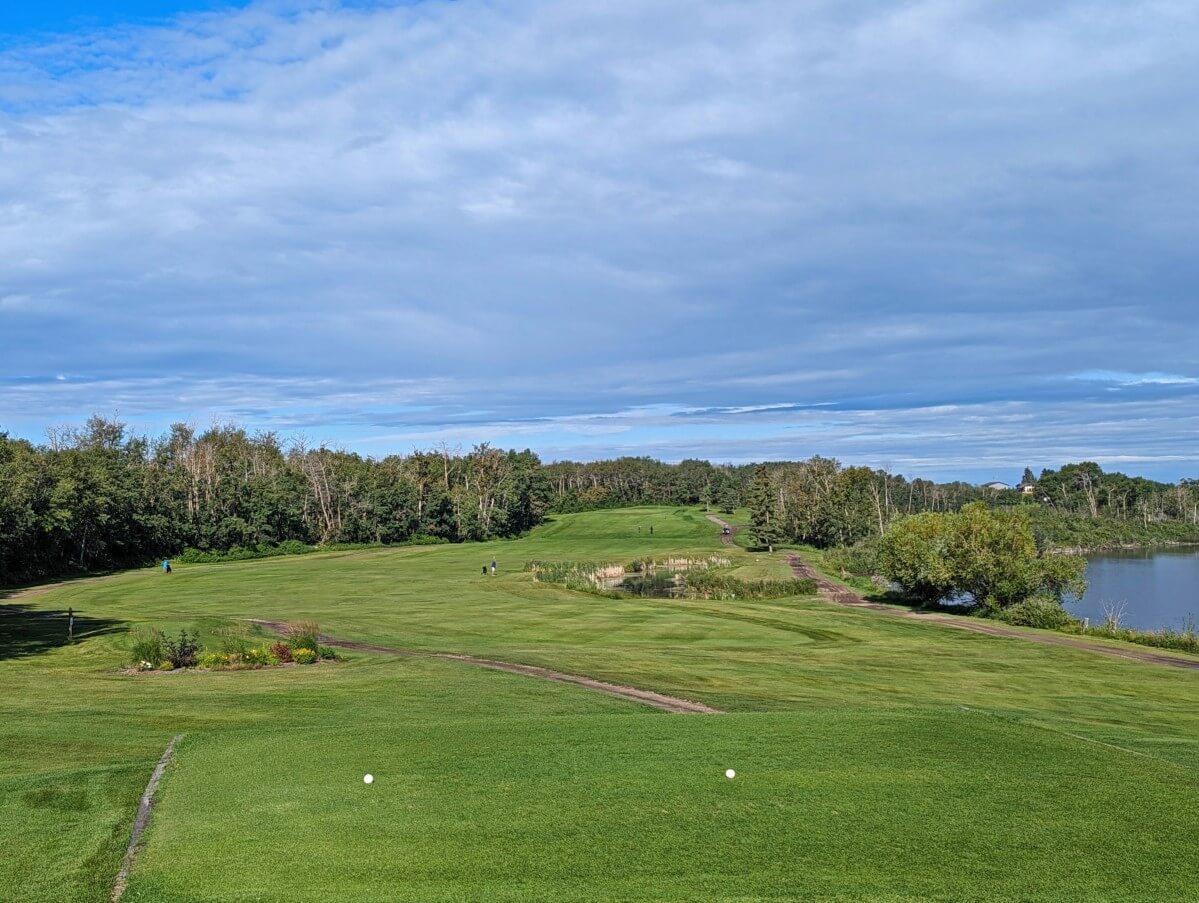 Haunted Lake Golf Club in Alix, with rolling green next to calm lake. This is one of the best things to do in Alix