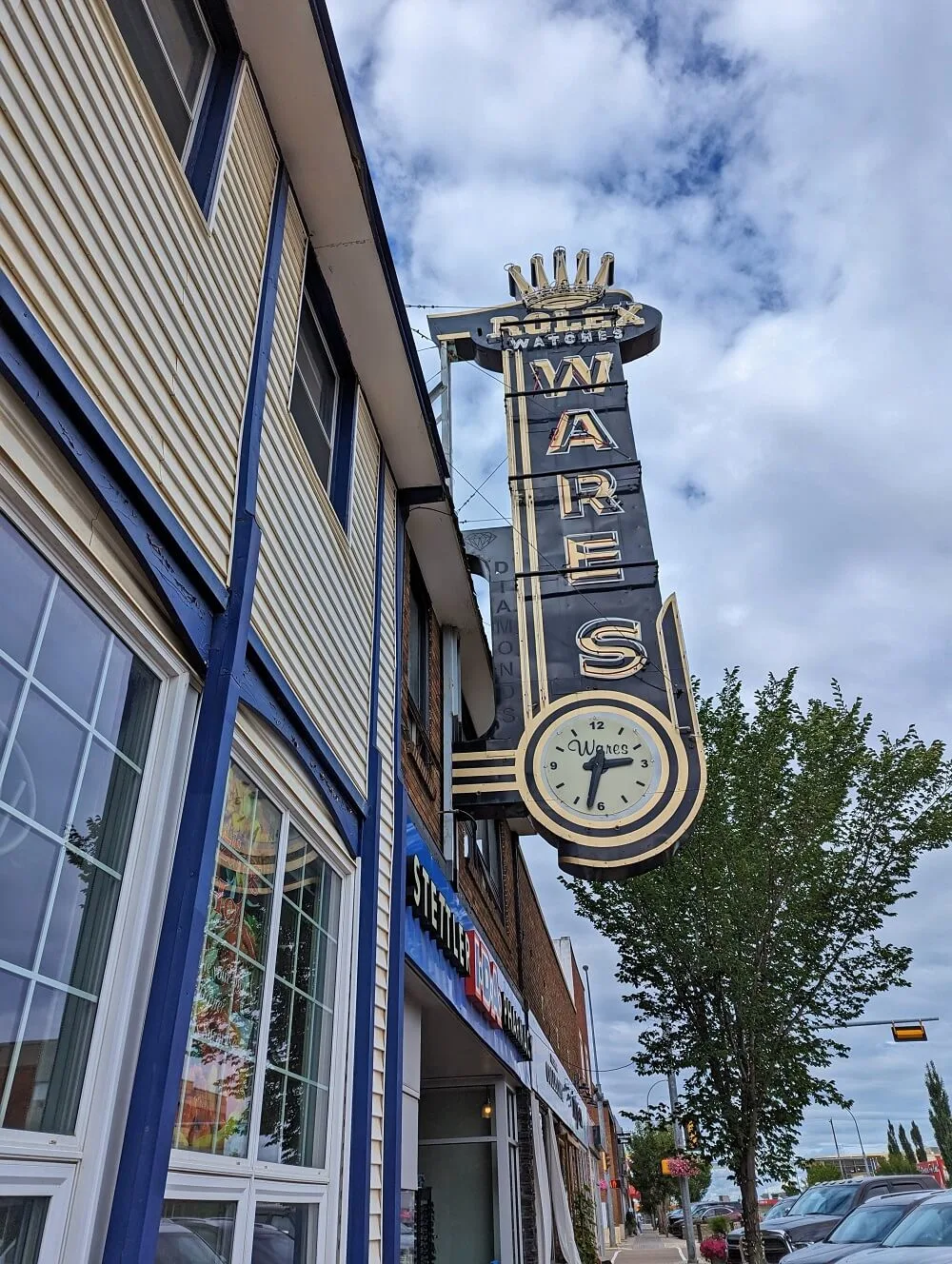 Close up of vintage Rolex Watches sign on side of downtown Stettler building