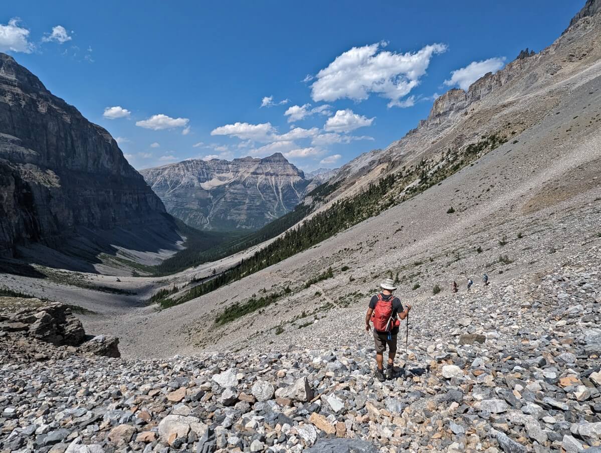 Back view of JR descending steep scree pathway on Stanley Glacier Trail