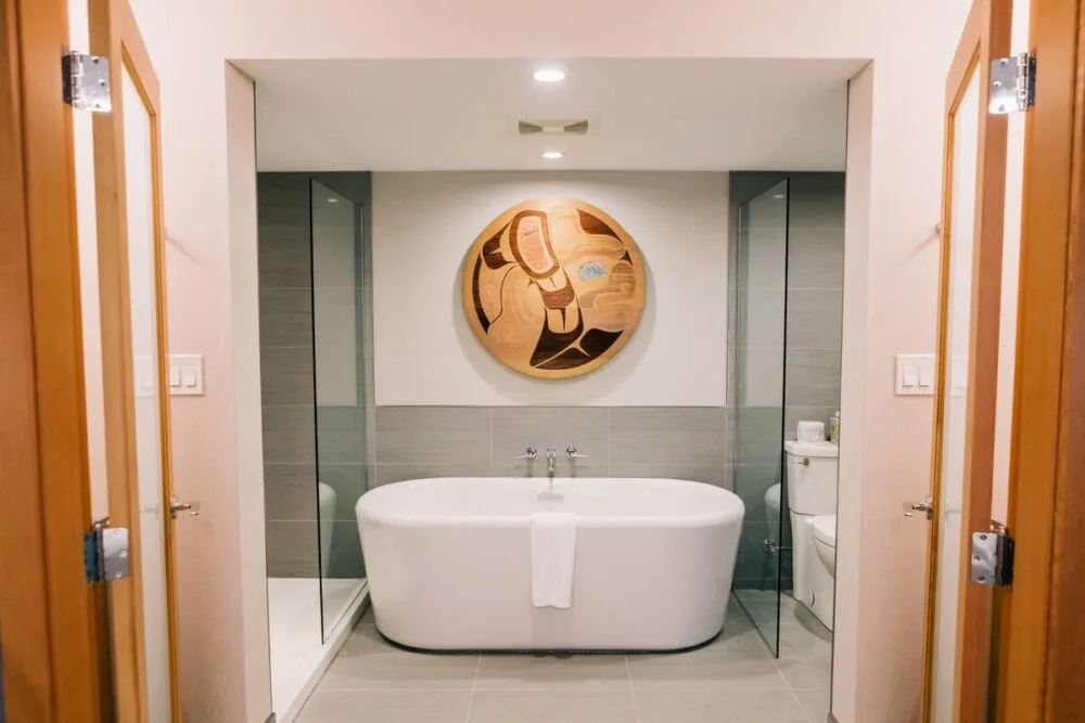 Kwalilas Hotel bathroom view with large free standing bath, Indigenous
wooden artwork above