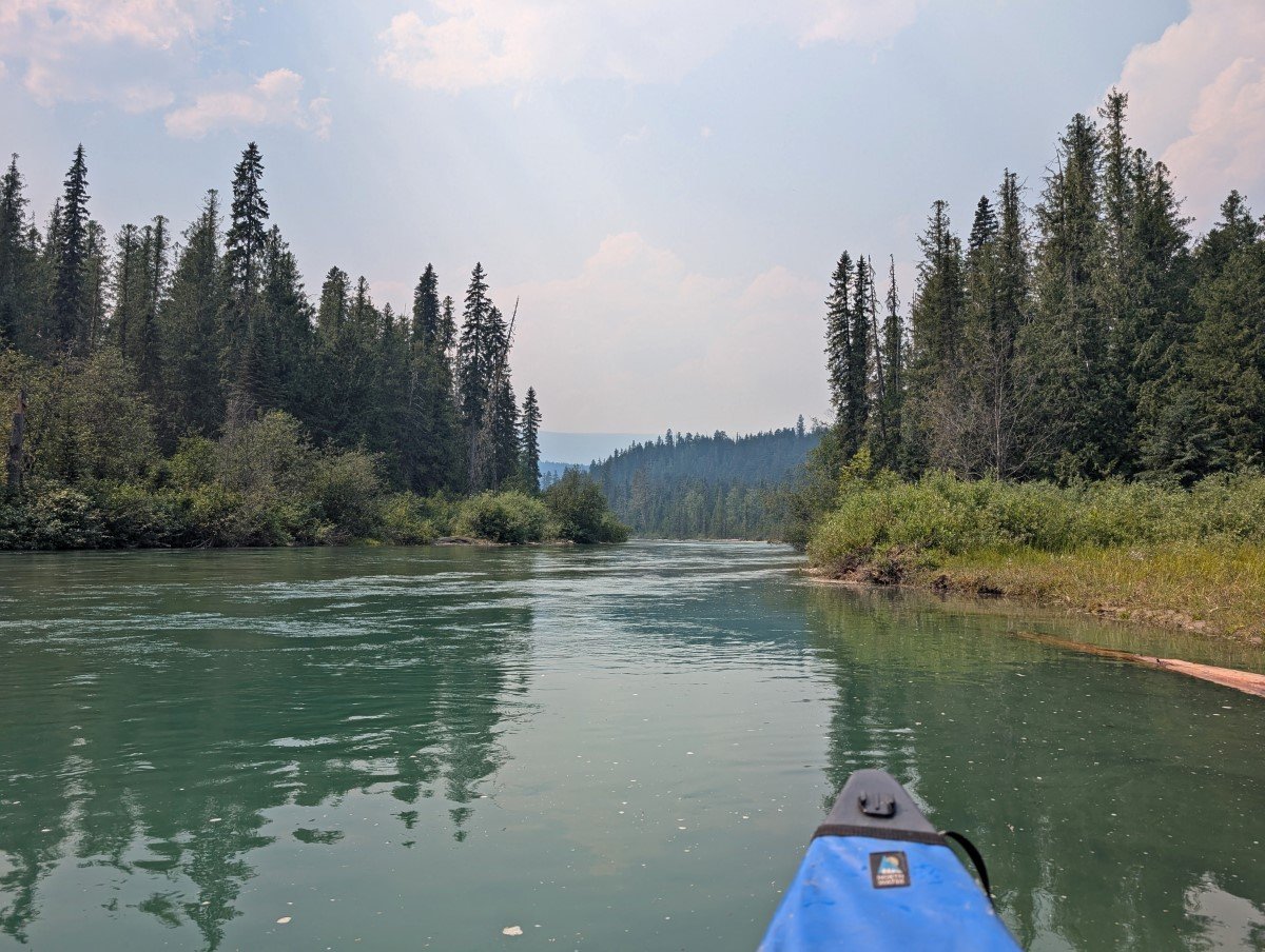 Canoe view of Clearwater River with forest lining both sides