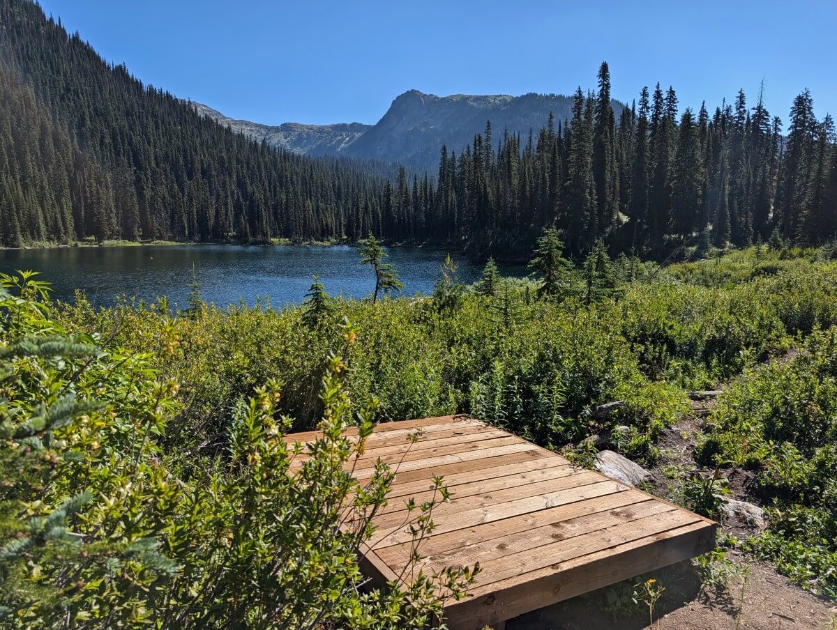 Wooden tent platform in front of subalpine Little Peters Lake in Monashee Provincial Park