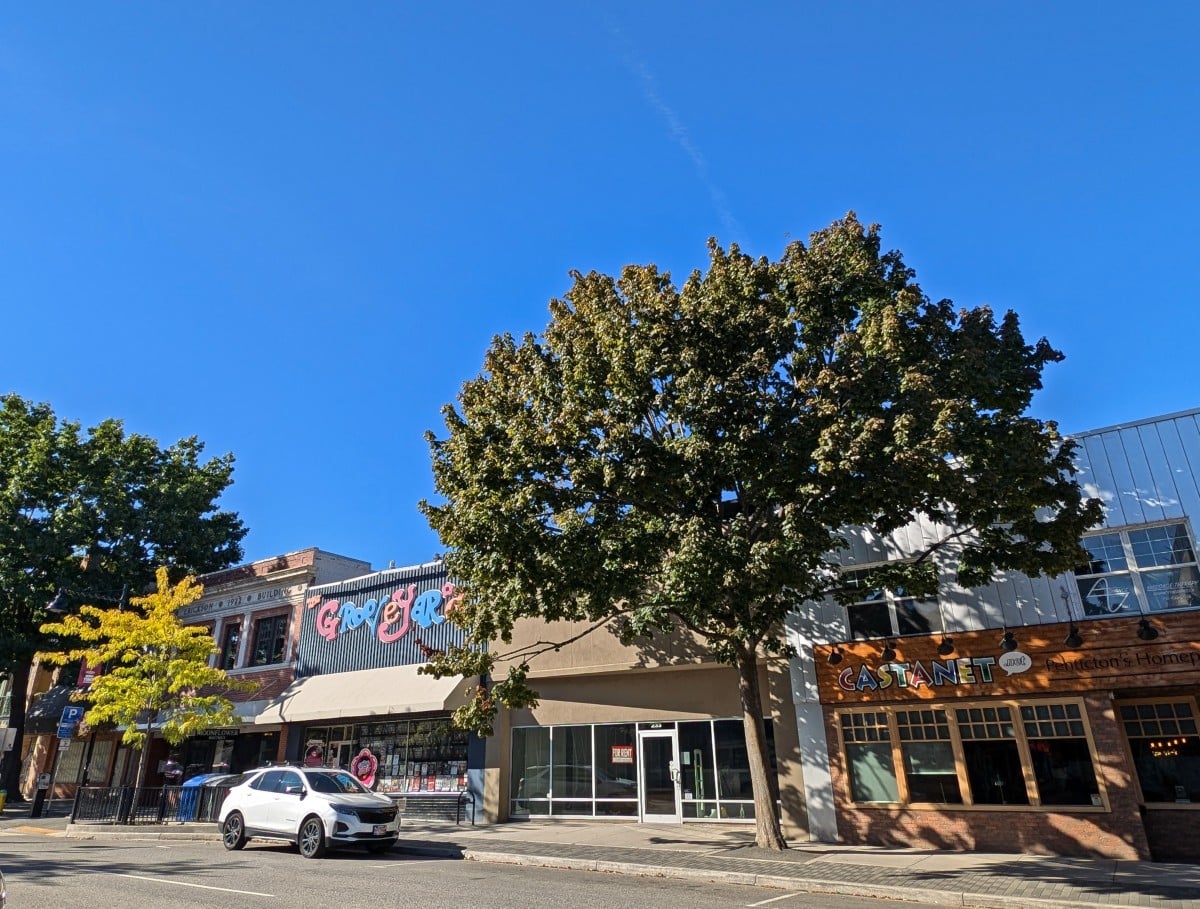 Street scene in downtown Penticton with colourful frontages and trees