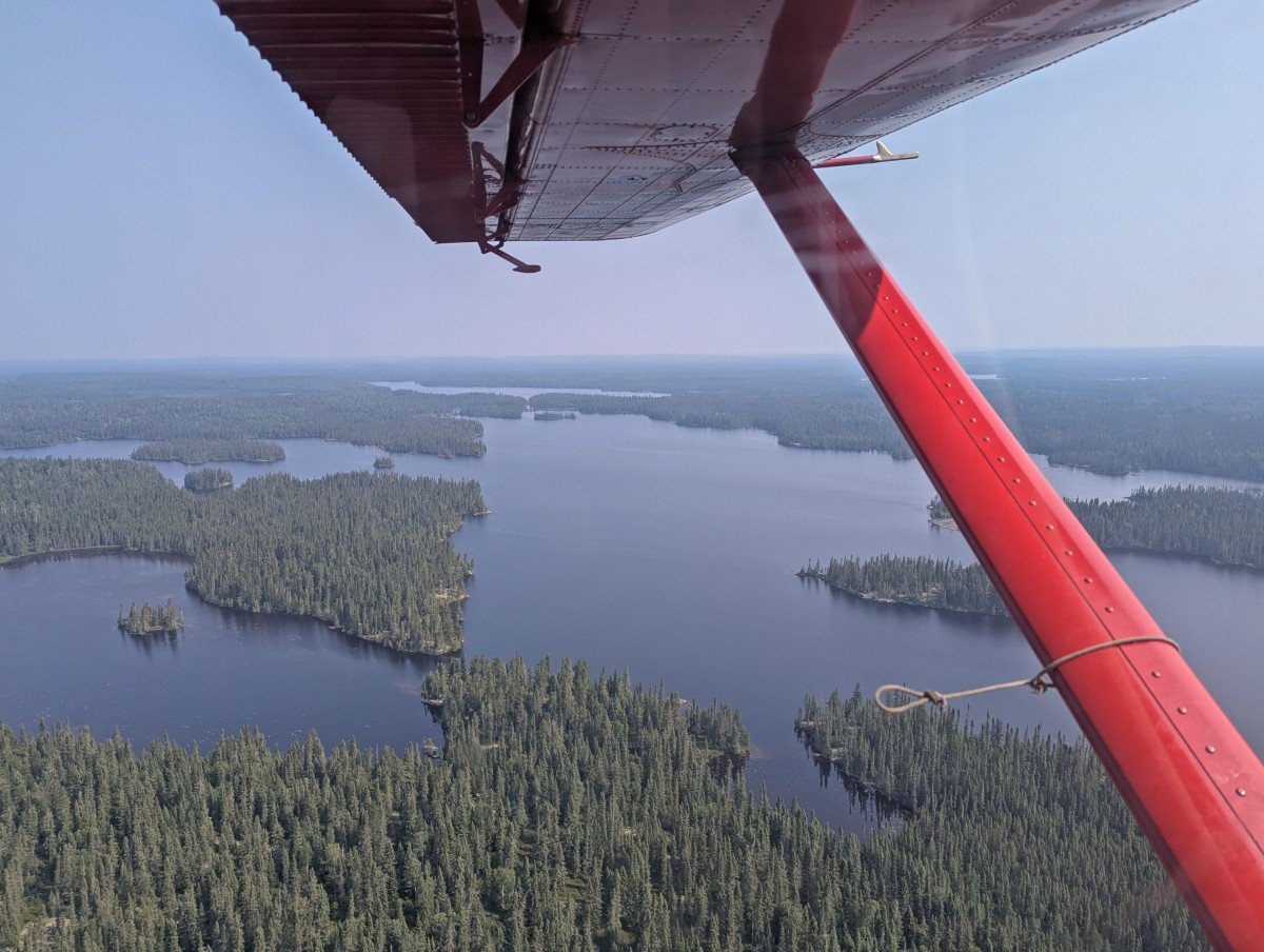Floatplane views looking down into Wabakimi Provincial Park, with a large lake, scattered islands and boreal forest below