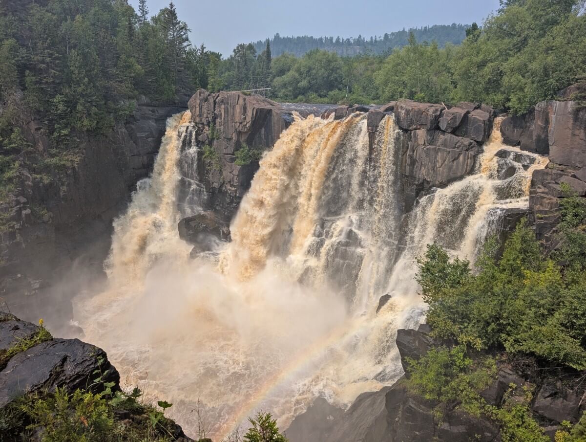 High Falls in Pigeon River Provincial Park, a powerful waterfall with multiple strong streams launching from rocky outcrop