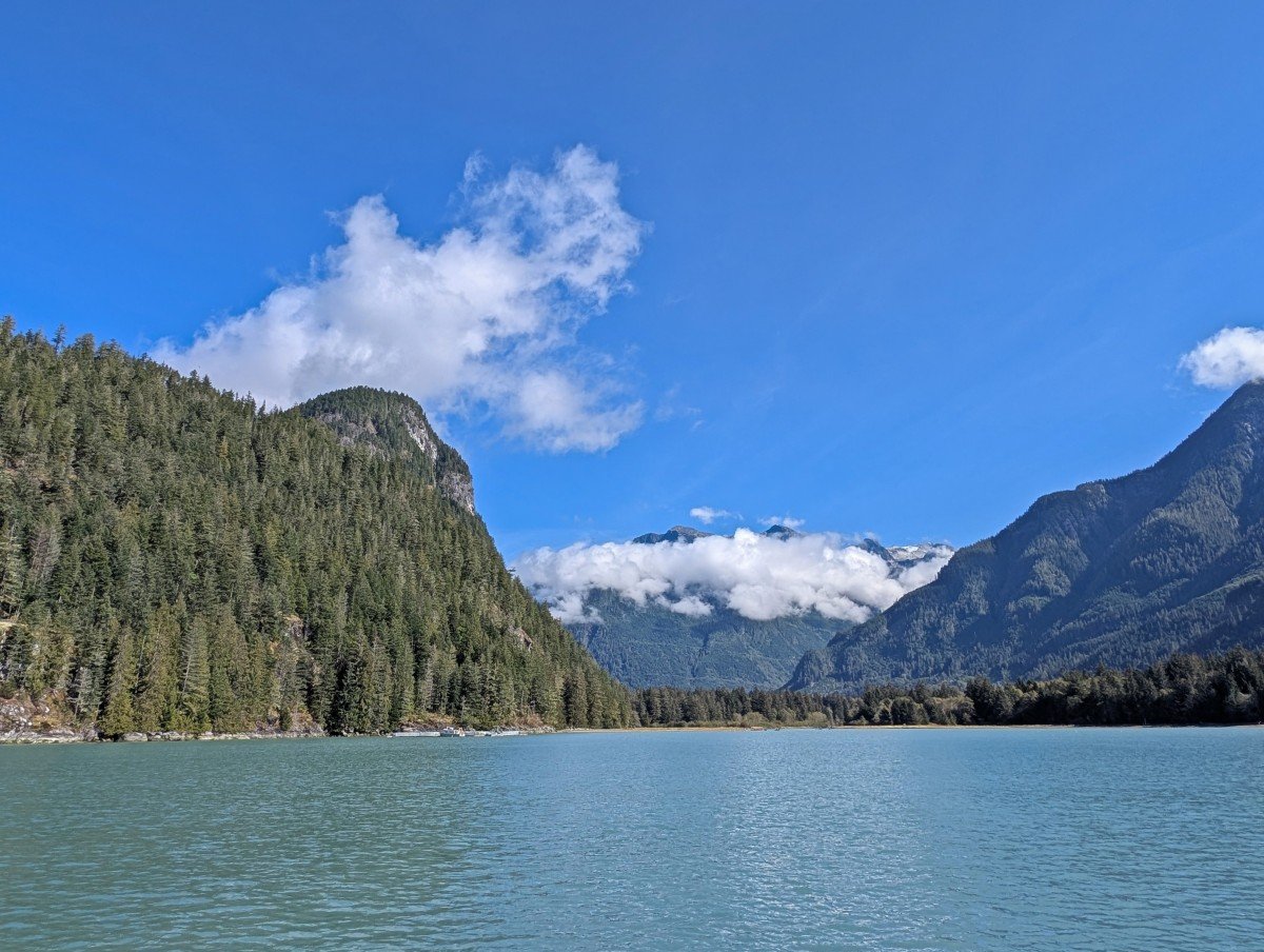 Bute Inlet views featuring calm turquoise coloured ocean and forested steep mountains