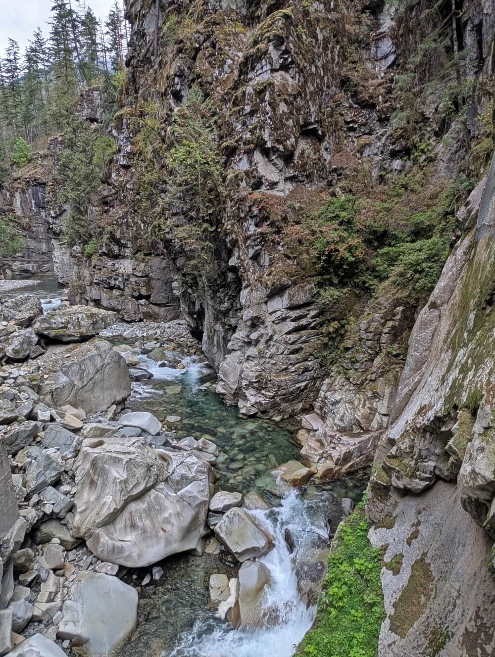 Looking down into Coquihalla Canyon, a steep granite sided gorge with rushing turquoise river below