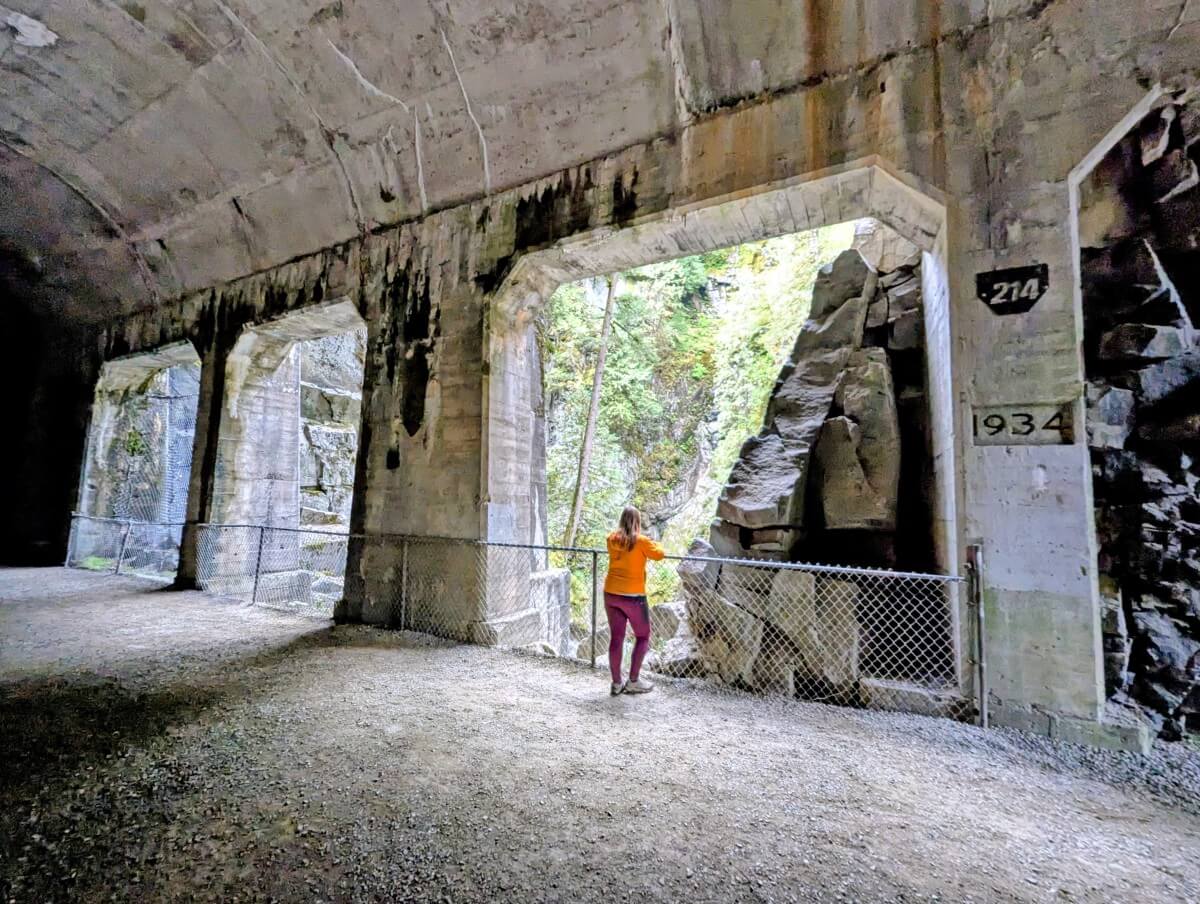 Back view of Gemma standing in opening ('window') on side of one of the Othello Tunnels