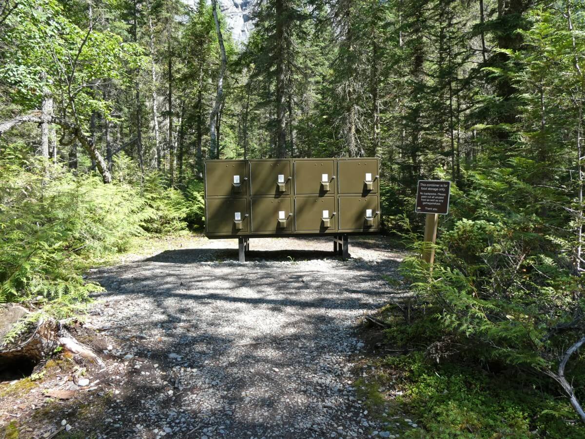 Kinney Lake Campground food caches, elevated metal boxes with forest background
