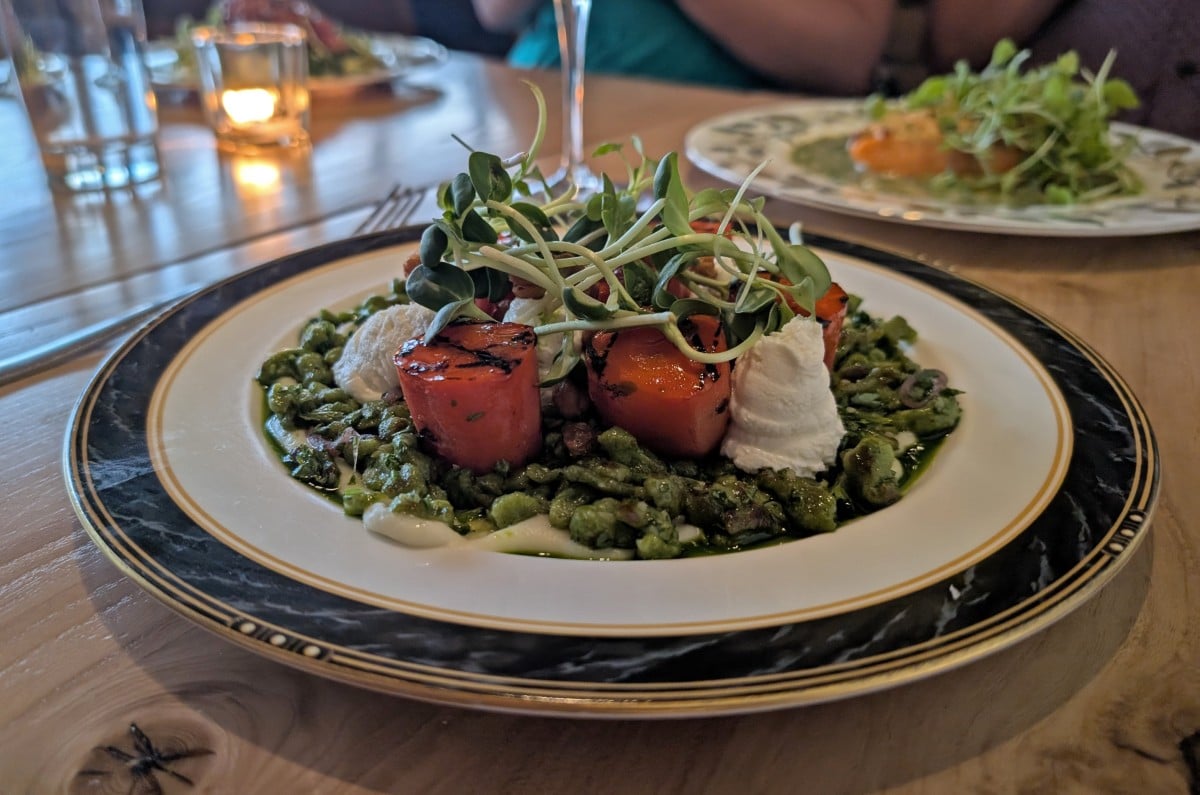 Close up of plant based dish at Hearth in Saskatoon, featuring peas, carrots, cheese and pea shoots