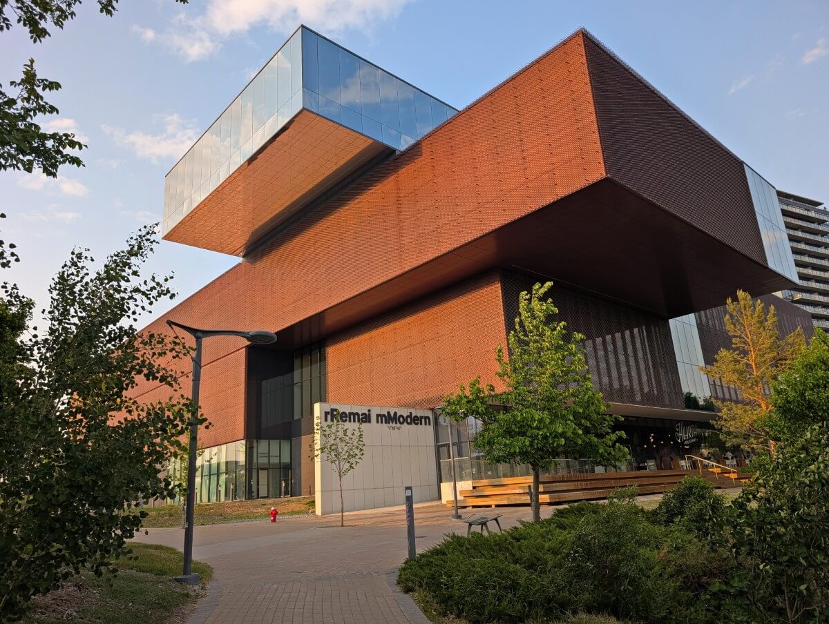 Looking up at the Remair Modern, a stacked box like building in downtown Saskatoon