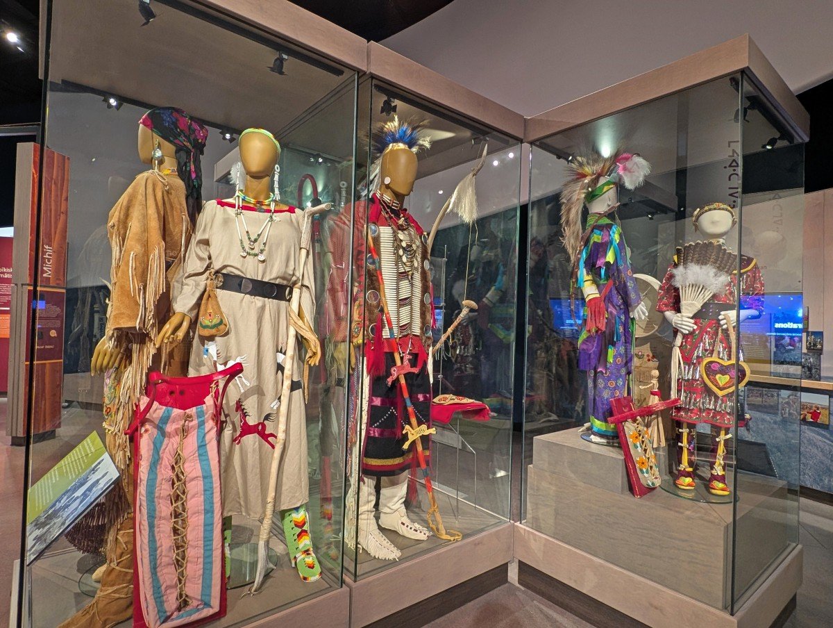 Close up of Indigenous clothing exhibits in glass boxes at Wanuskewin in Saskatoon