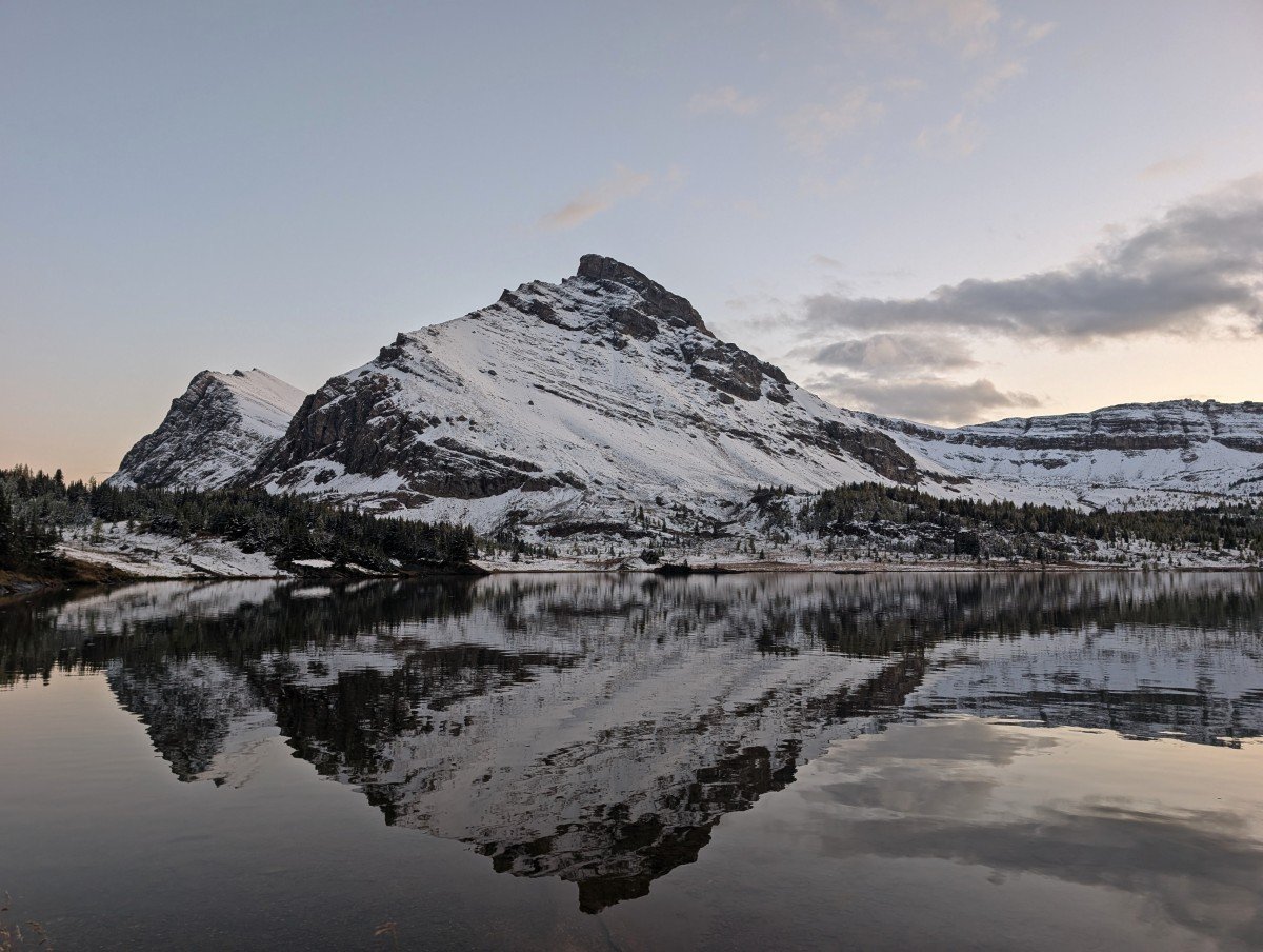 Calm evening on Baker Lake, with reflections of large snow covered mountain 