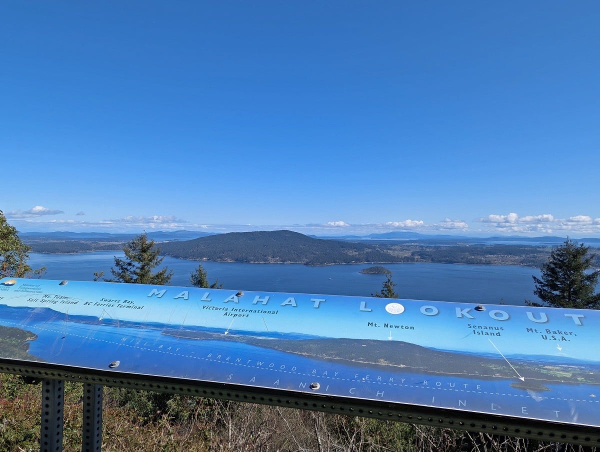 Split Rock Lookout view on the Malahat with interpretive board in the foreground and amazing ocean, forested peninsula and islands views in background