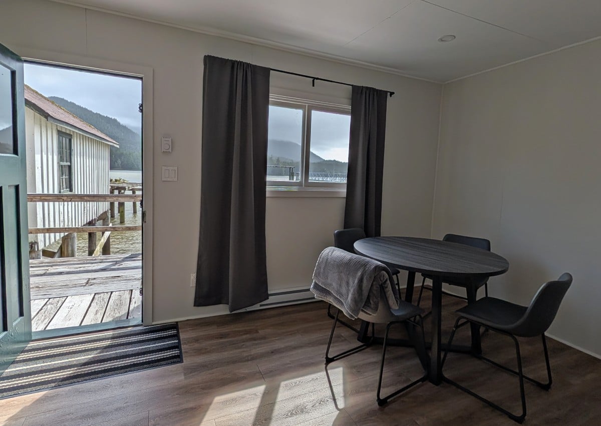 Japanese Triplex view with table and four chairs, open door to boardwalk and ocean views visible in background