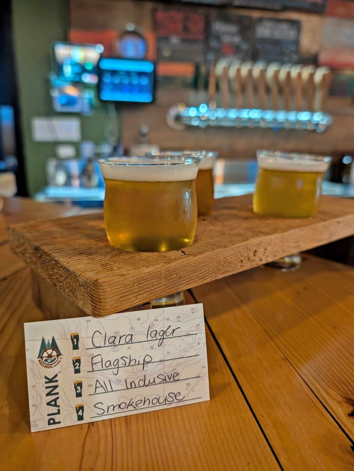 Close up of brewery flight with three different amber coloured beers in Prince Rupert