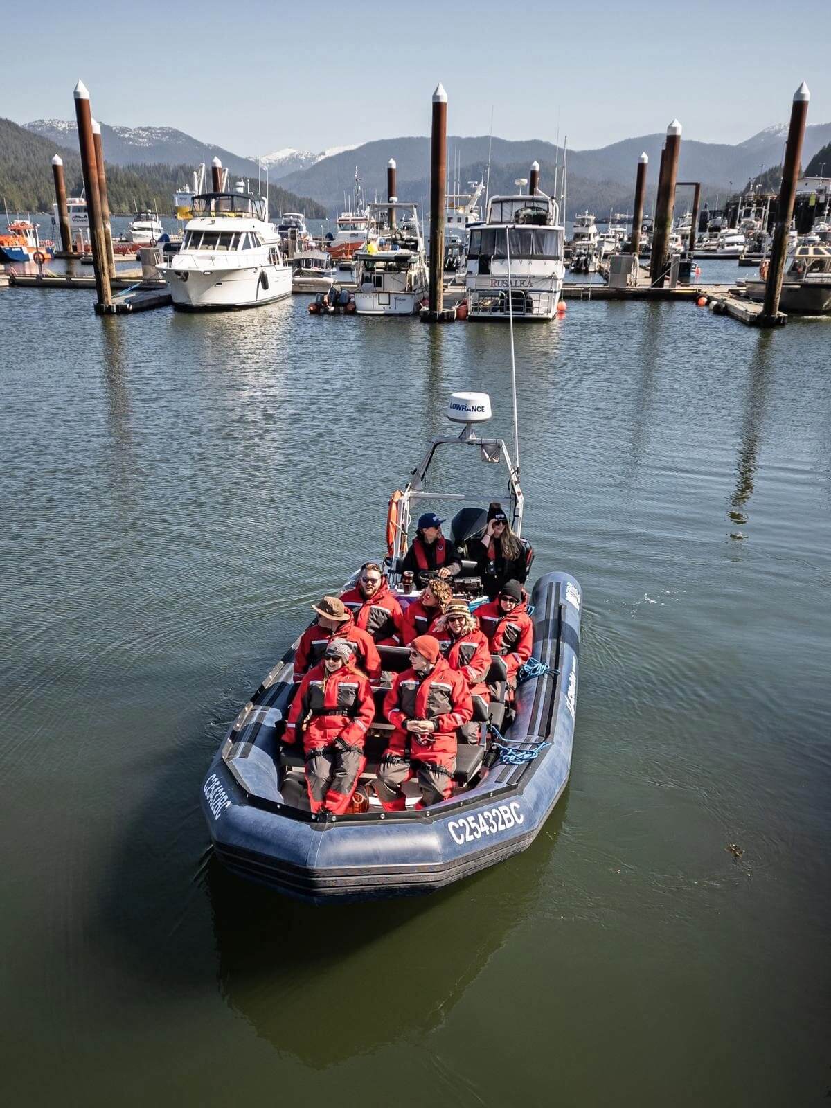Drone view of RIBTide Zodiac boat in Prince Rupert harbour, with mountains visible in the background