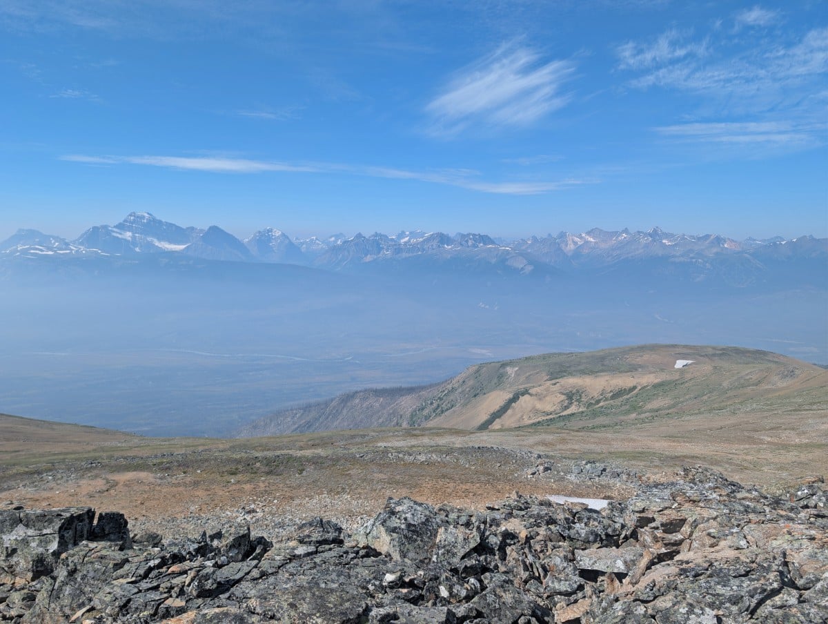 Looking over rocks to wide mountain views from the ridge on the Skyline Trail