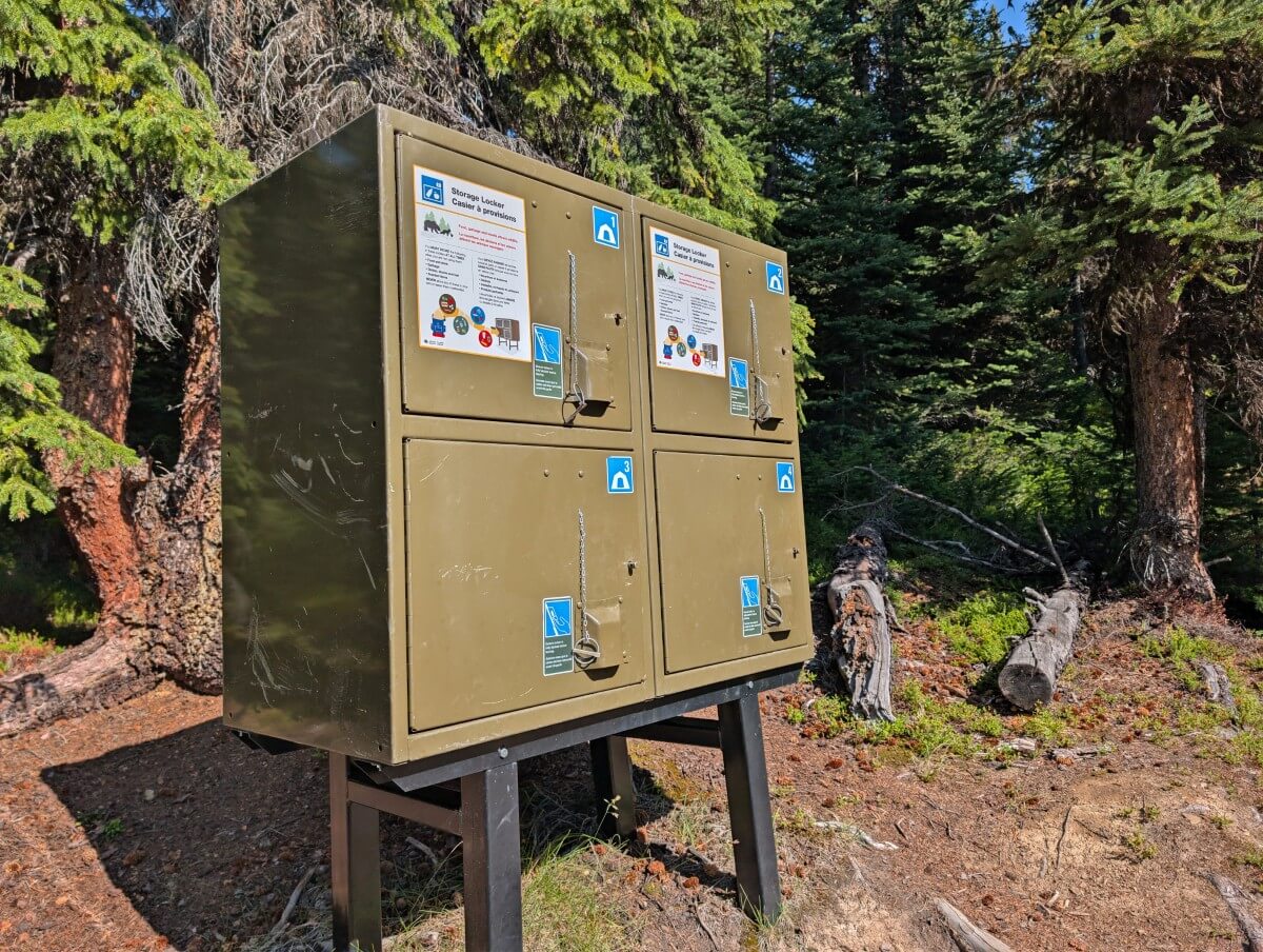 Close up of four sectioned metal food cache at a campground on the Skyline Trail