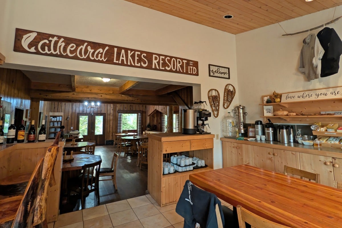 Cathedral Lakes Lodge interior view with signage, tables, coffee area