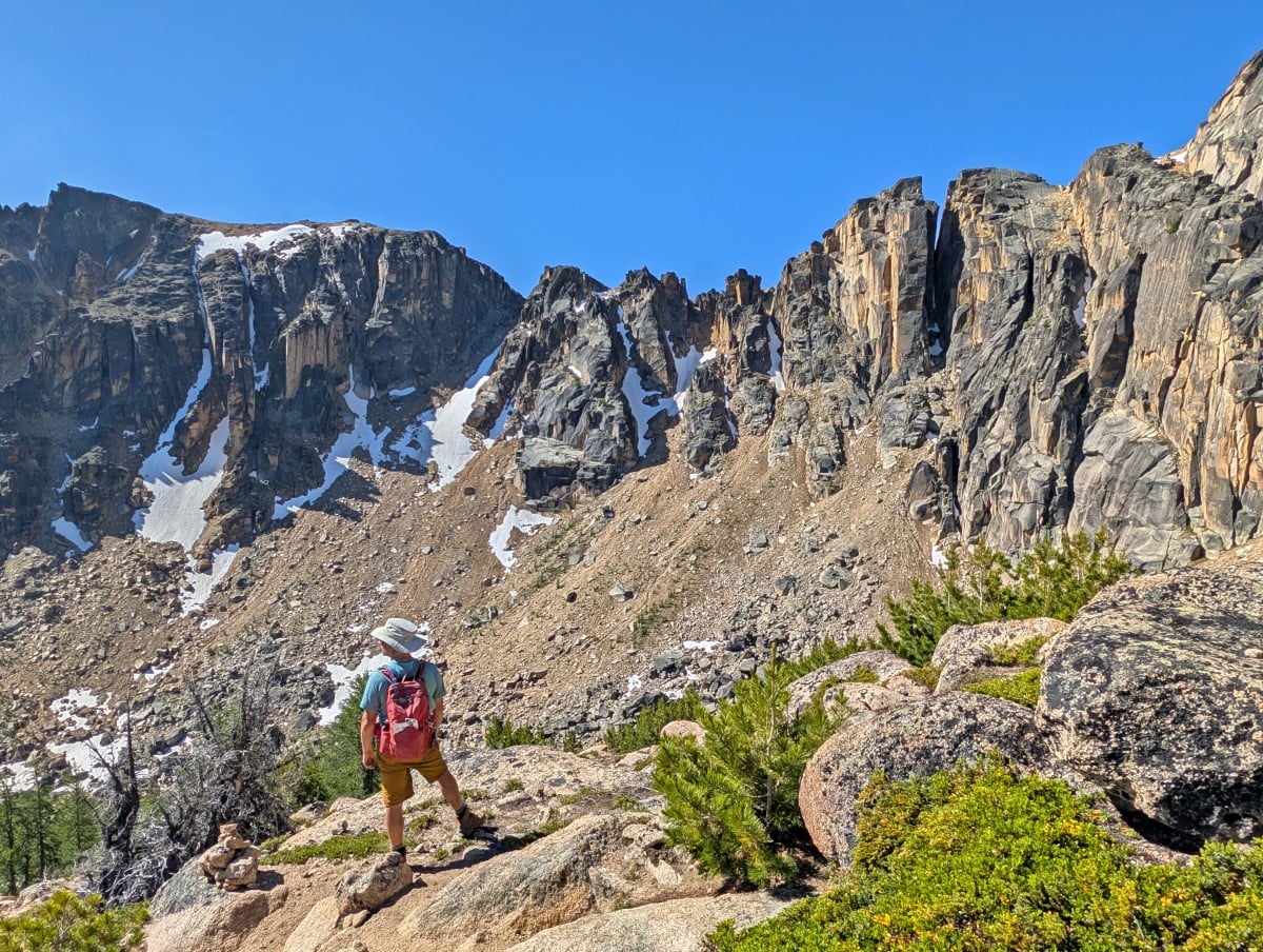 Back view of JR standing in front of impressive mountain view in Cathedral Provincial Park